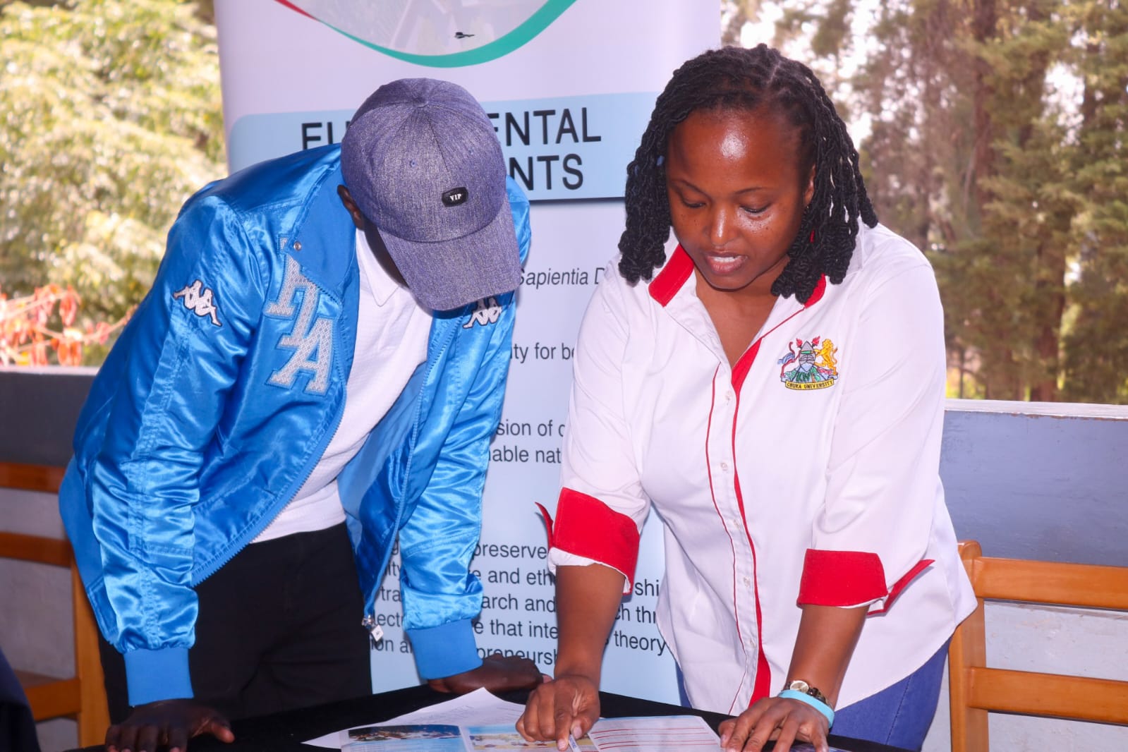 Mr. Anthony Kimani(Treasurer) consulting during the event